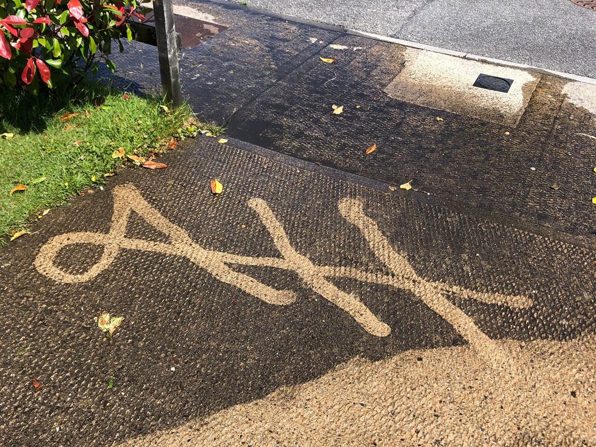 A.H written into a dirty driveway by a pressure washer